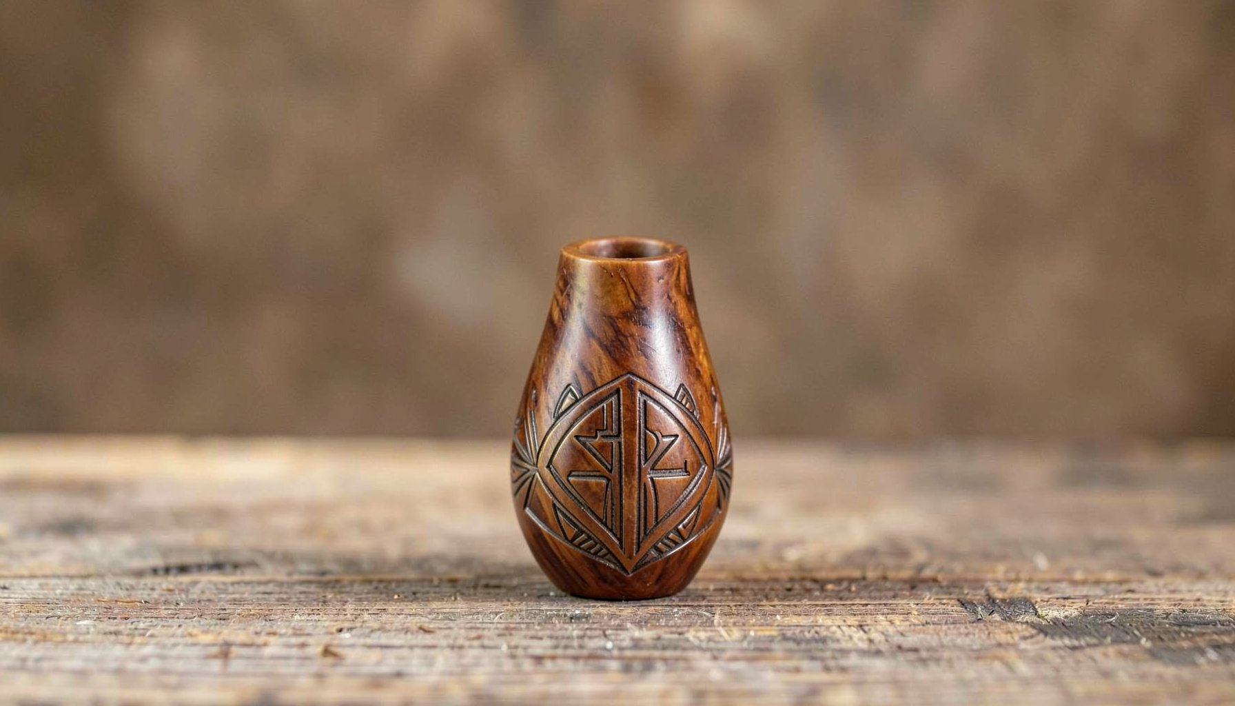 Artisan pipe with a tall slender bowl and subtle carving detail, resting on aged wood with soft natural light