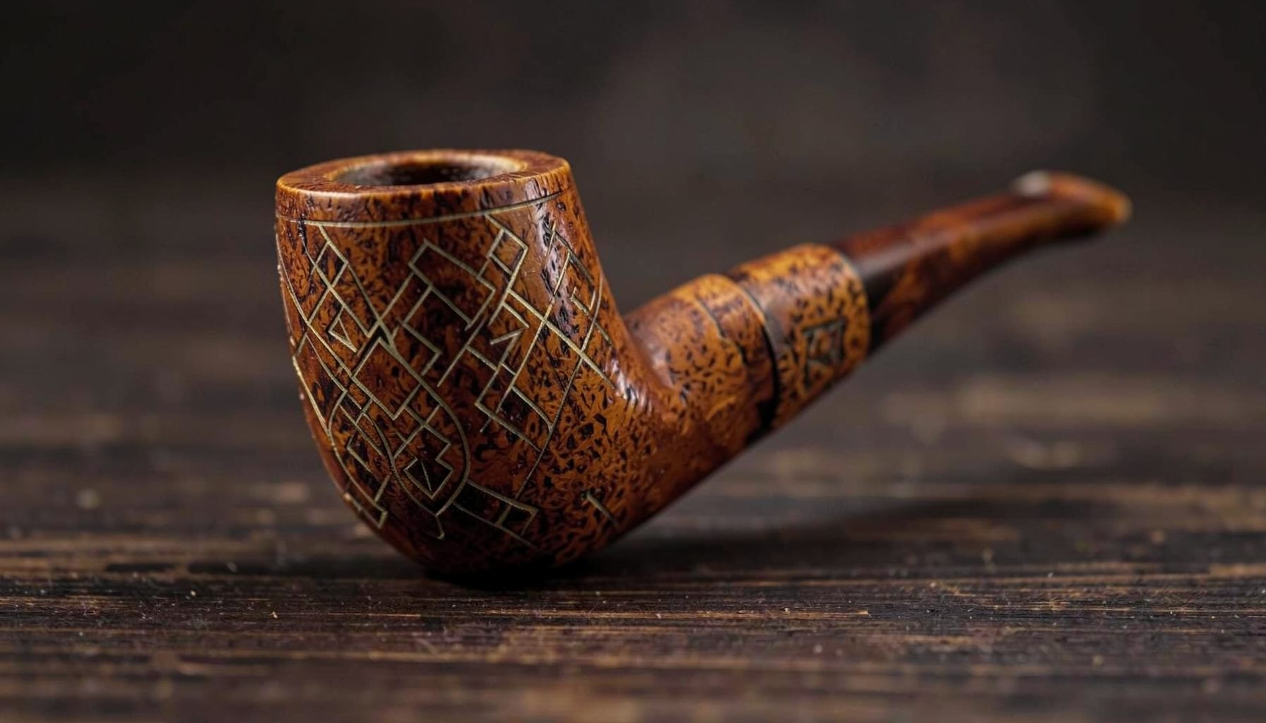 Warm-toned artisan pipe with a broad rusticated bowl resting on a dark wooden surface, soft side light